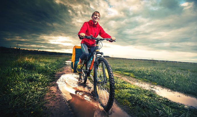 cyclist riding across wet moorland 