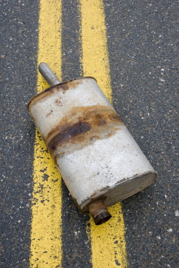 rusty exhaust pipe lying in road