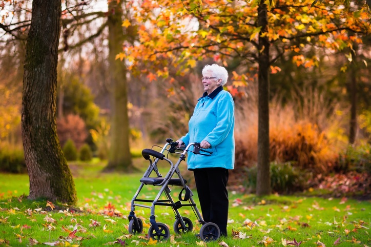 older lady in wood with walking frame