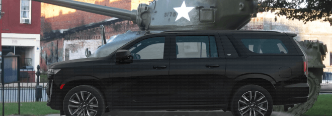 SUV parked in front of sherman tank